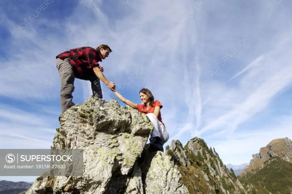 Couple climbing on summit