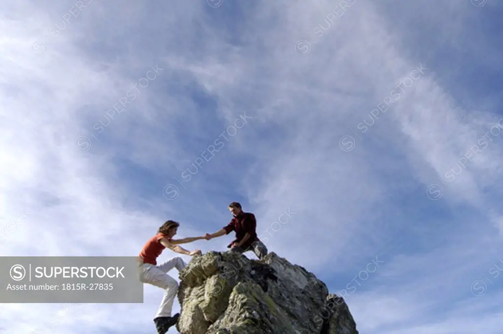Couple climbing on summit