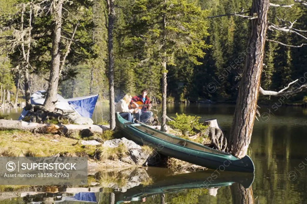 Young couple camping at lake