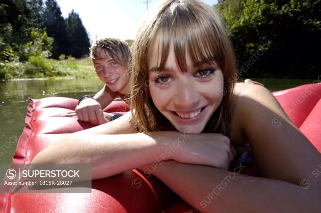 Young couple lying on air mattress