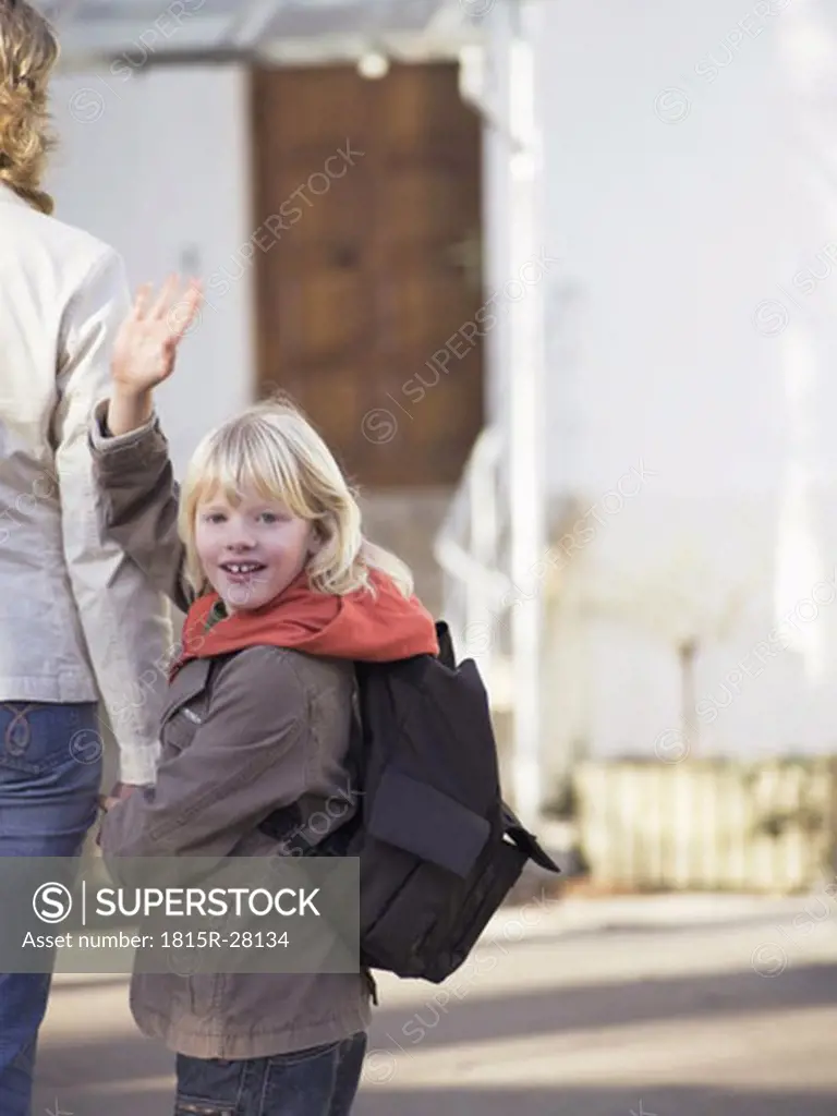 Mother bringing boy to school