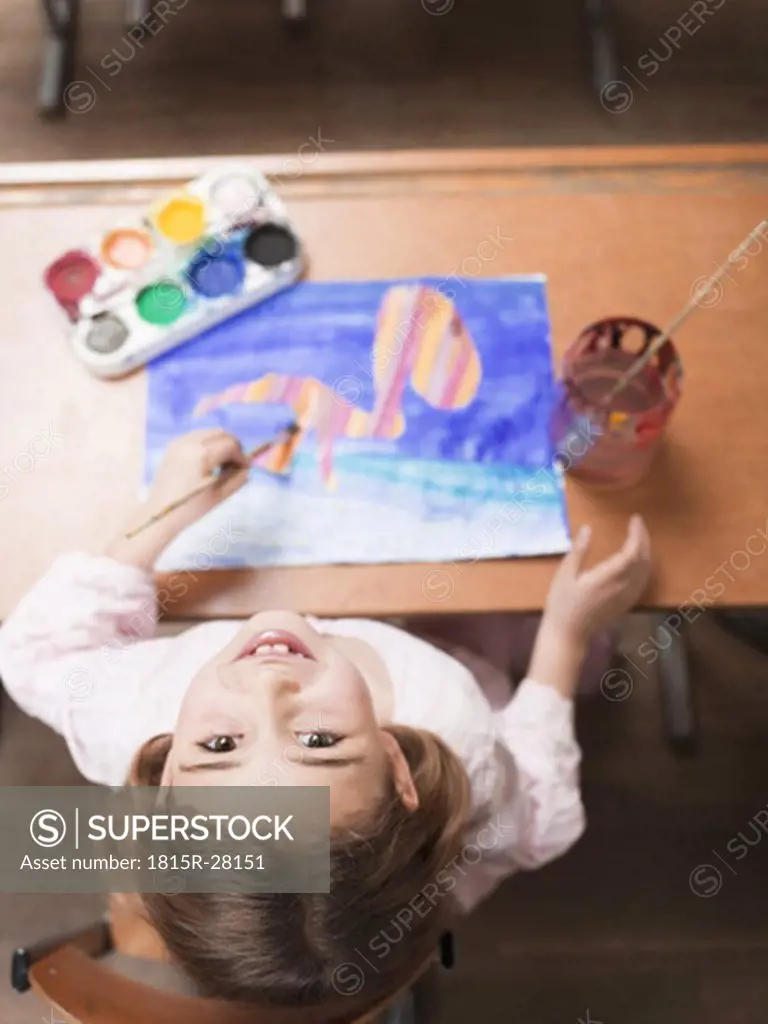 Girl painting with water colours