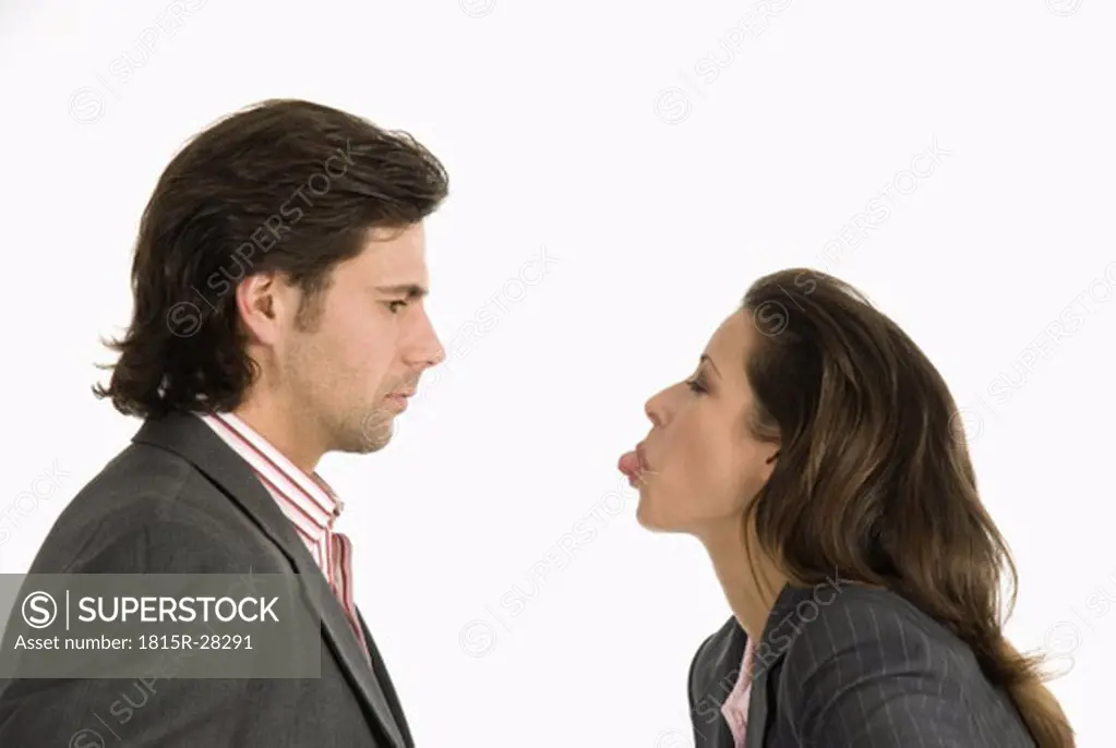 Businessman and businesswoman discussing, side view