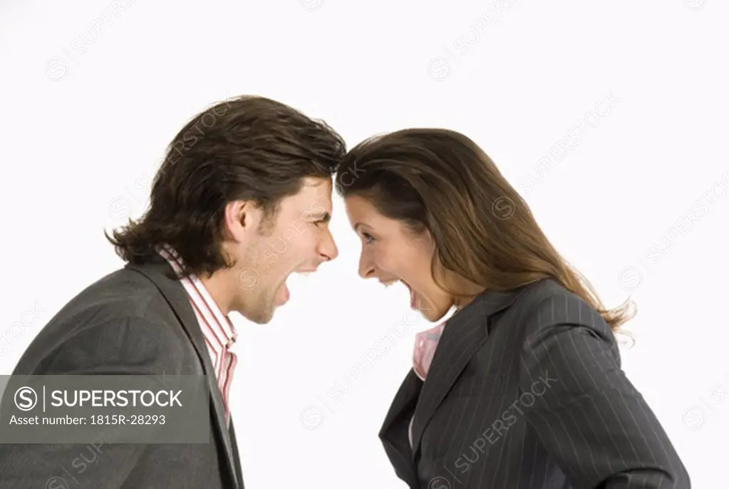 Businessman and businesswoman discussing, side view