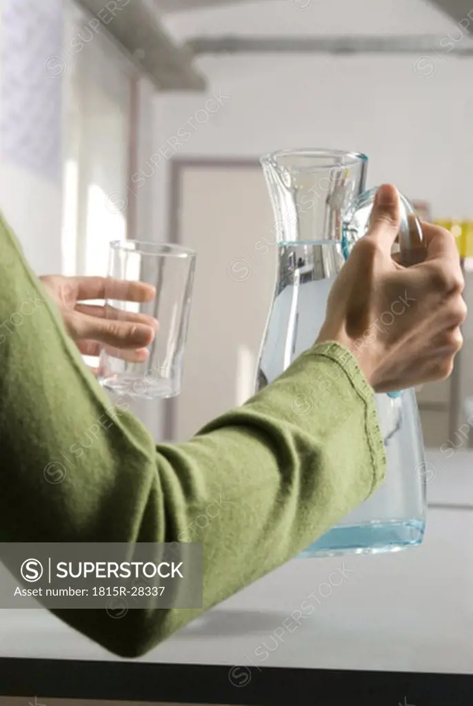 Woman pouring water, close-up