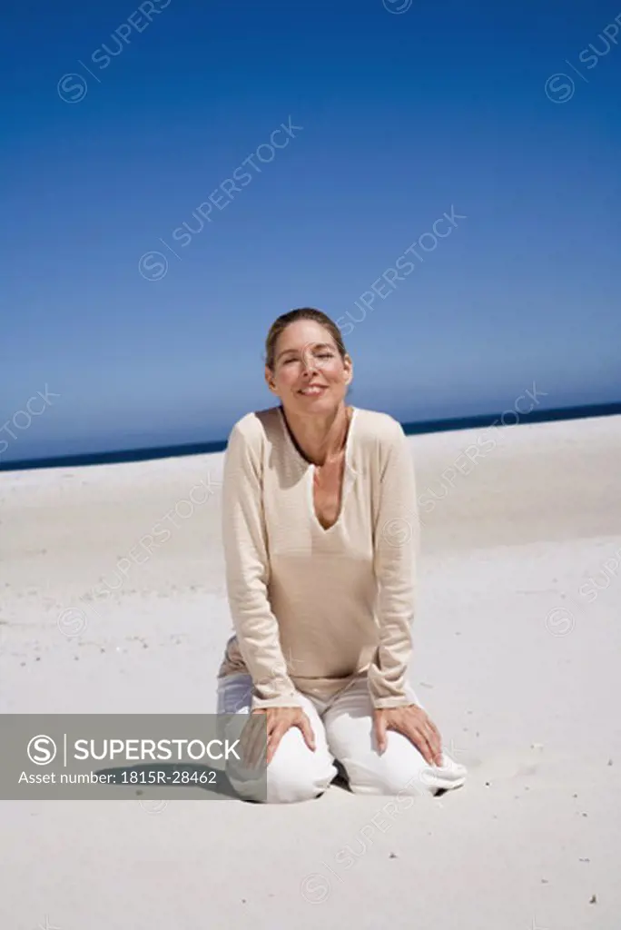 Mature woman sitting on beach