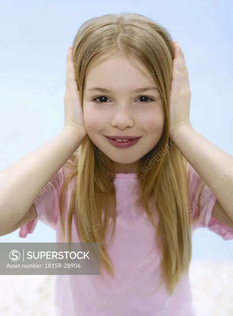 Girl 6-7, holding ears, portrait