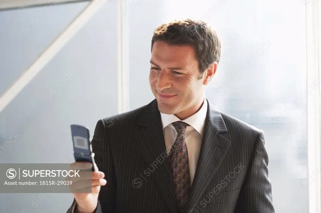 Business man, using mobile phone, close-up