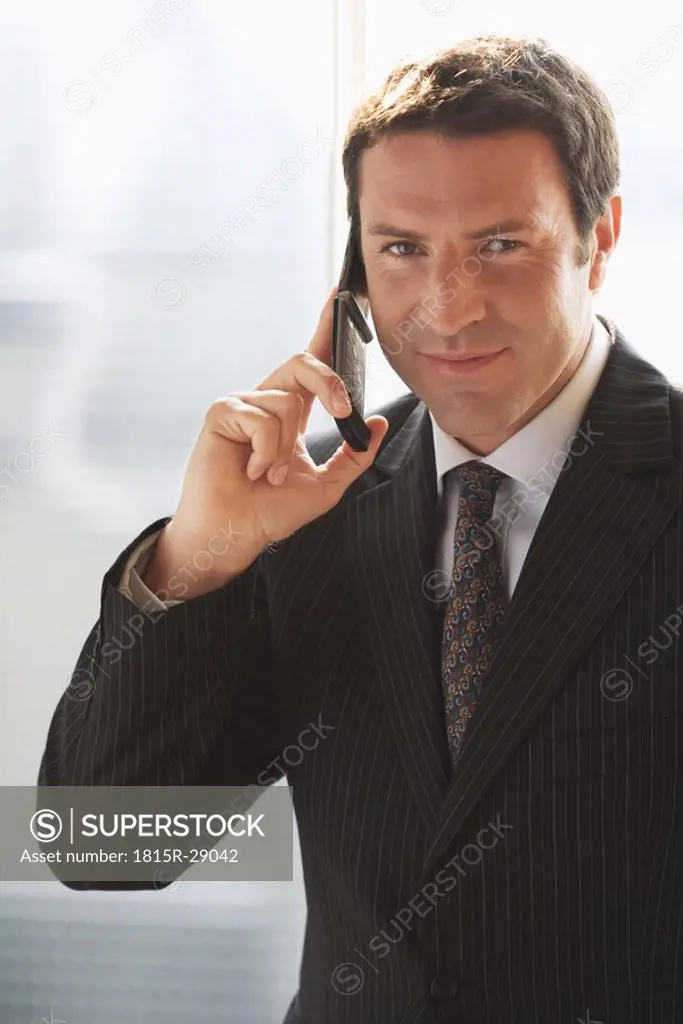 Business man, using mobile phone, close-up