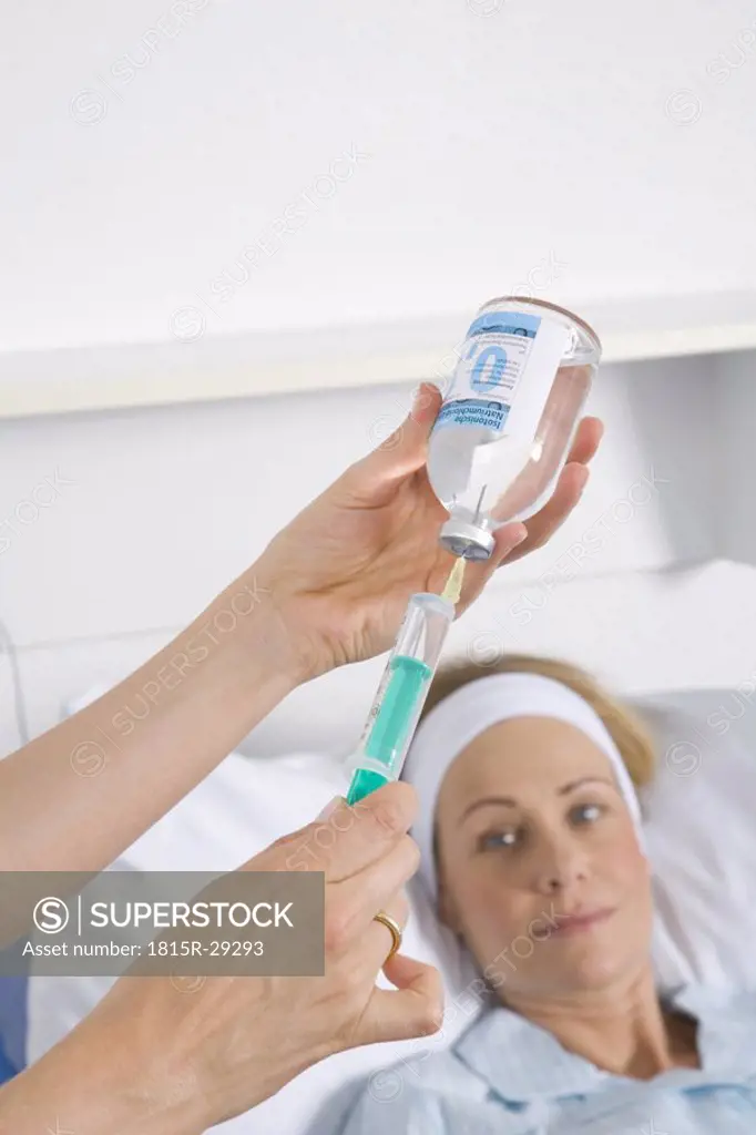 Nurse filling a Syringe