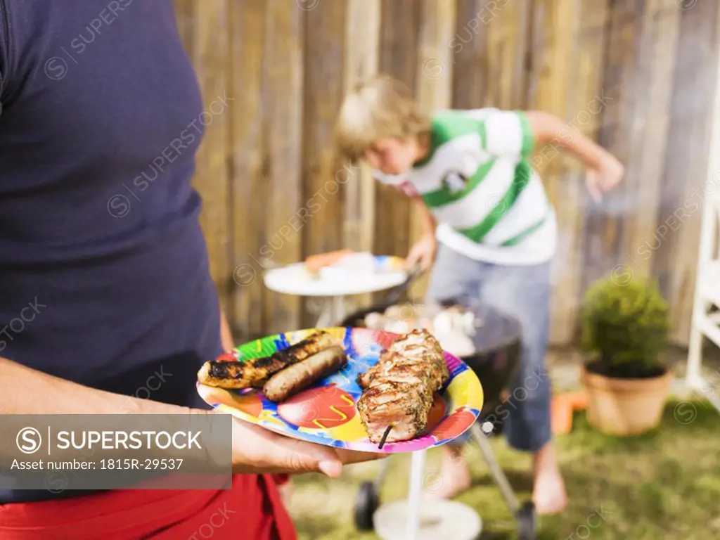 Father and son having barbecue