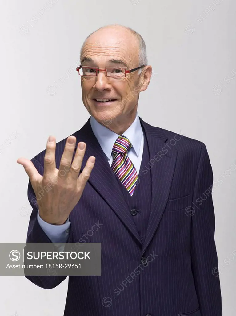 Businessman making hand gesture, portrait