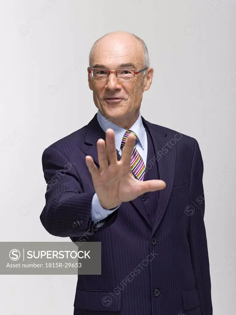Businessman making hand gesture, portrait