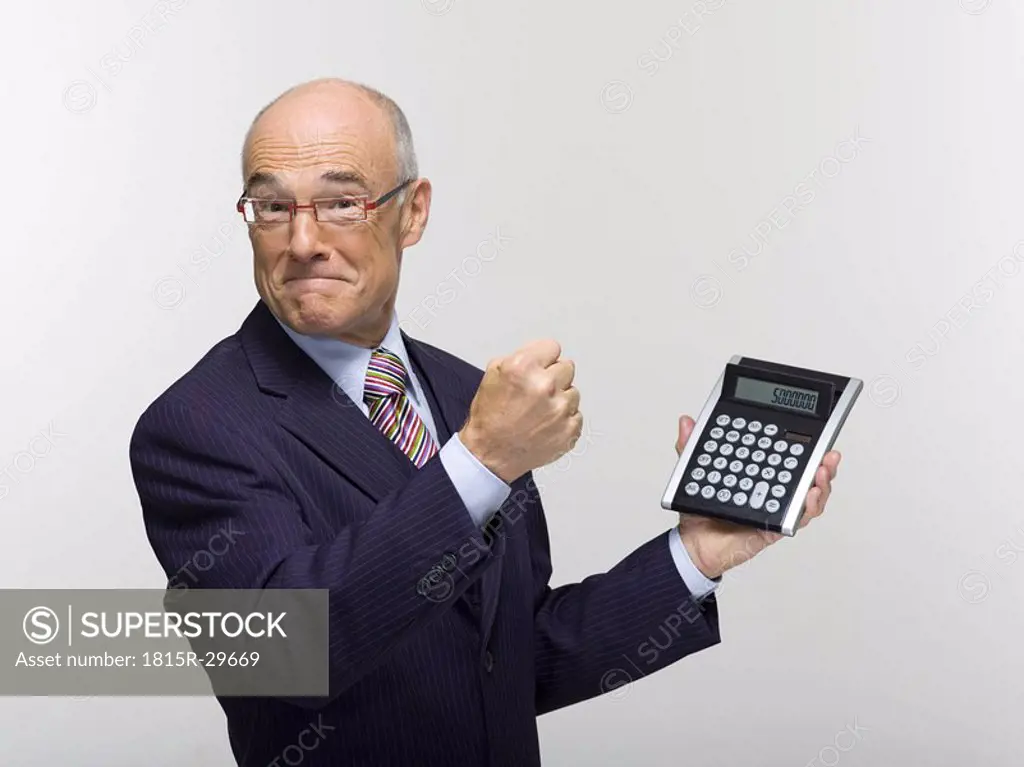 Businessman holding calculator, portrait