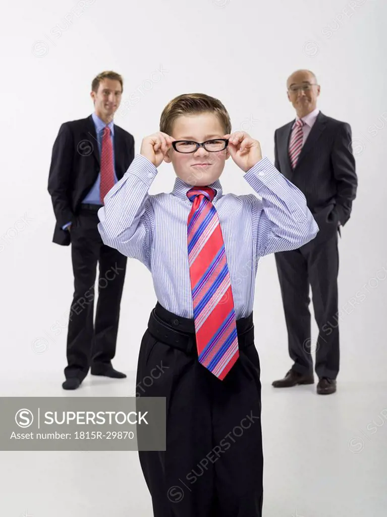 Grandson 8-9 grandfather and son wearing business cloth, portrait