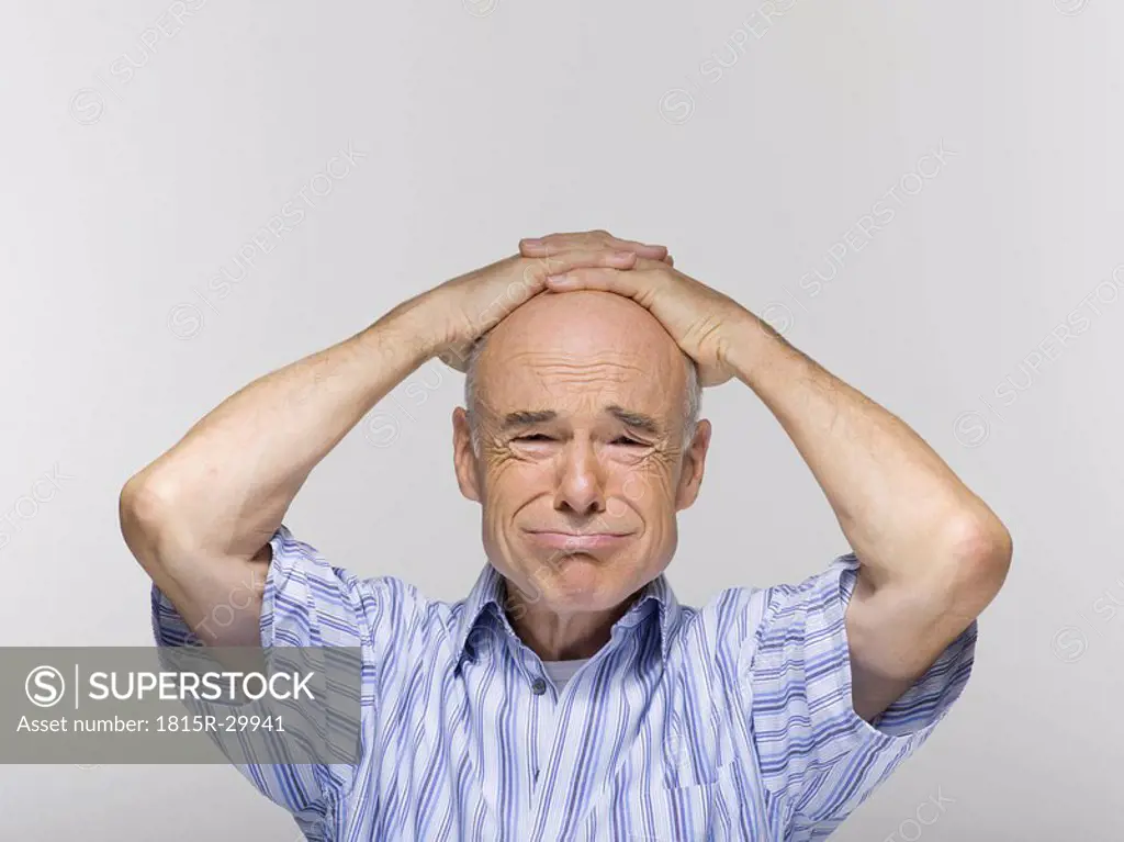 Senior man, hands clasped on head, portrait, close-up