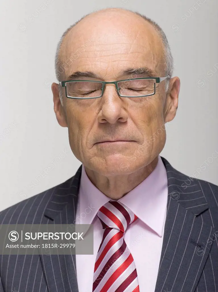 Portrait of a Senior businessman eyes closed, close-up