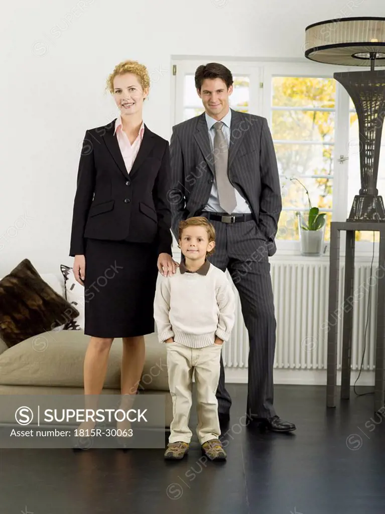 Family standing in livingroom, portrait