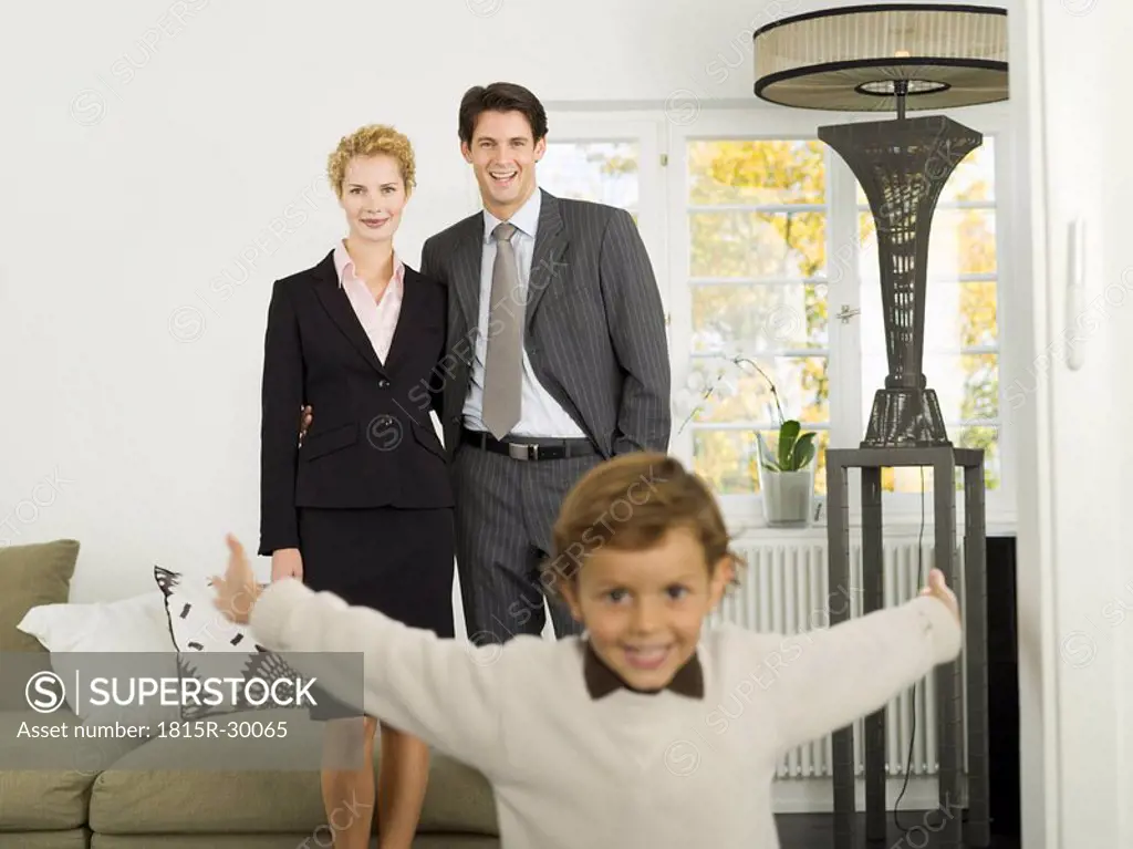 Family standing in livingroom, portrait
