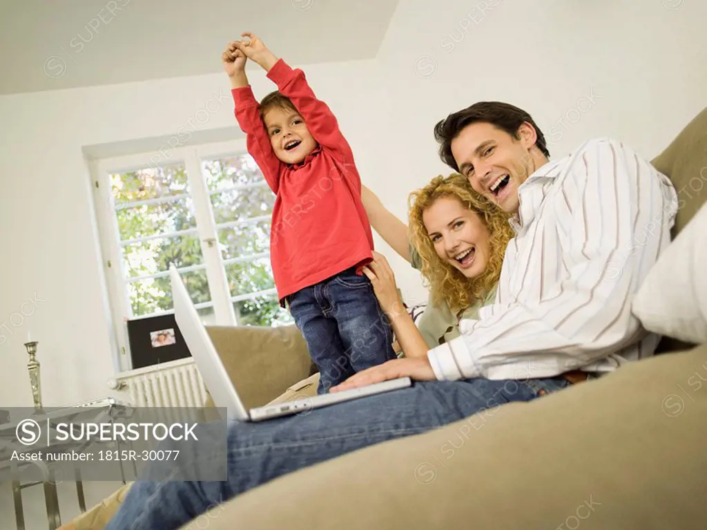 Young family in living room, smiling