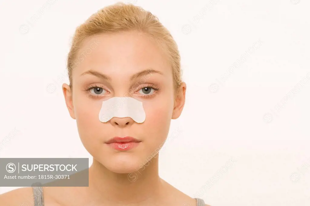 Woman wearing an adhesive plaster over nose, portrait
