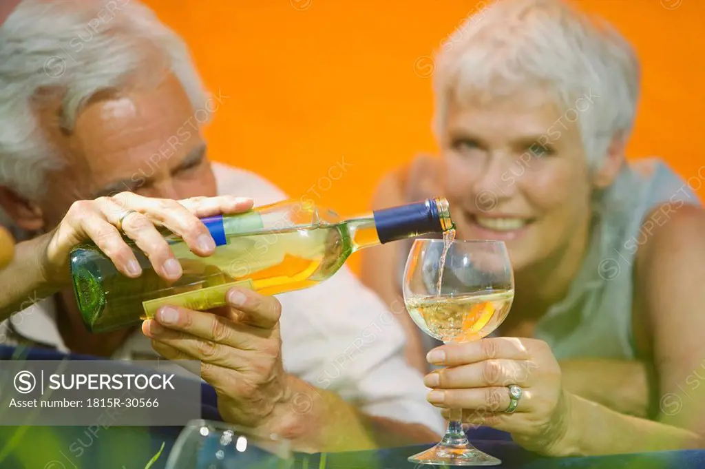Senior couple drinking white wine, portrait