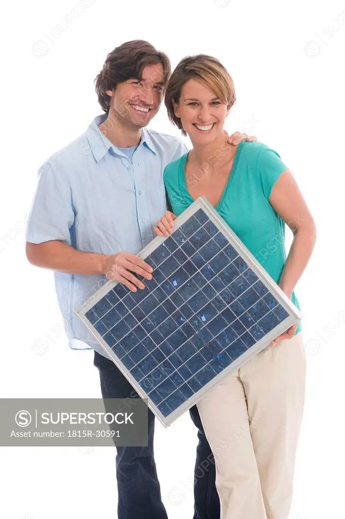 Couple holding solar panel