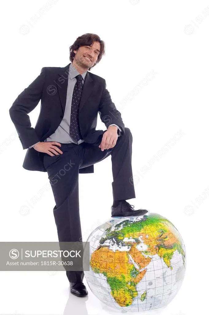 Businessman standing by globe
