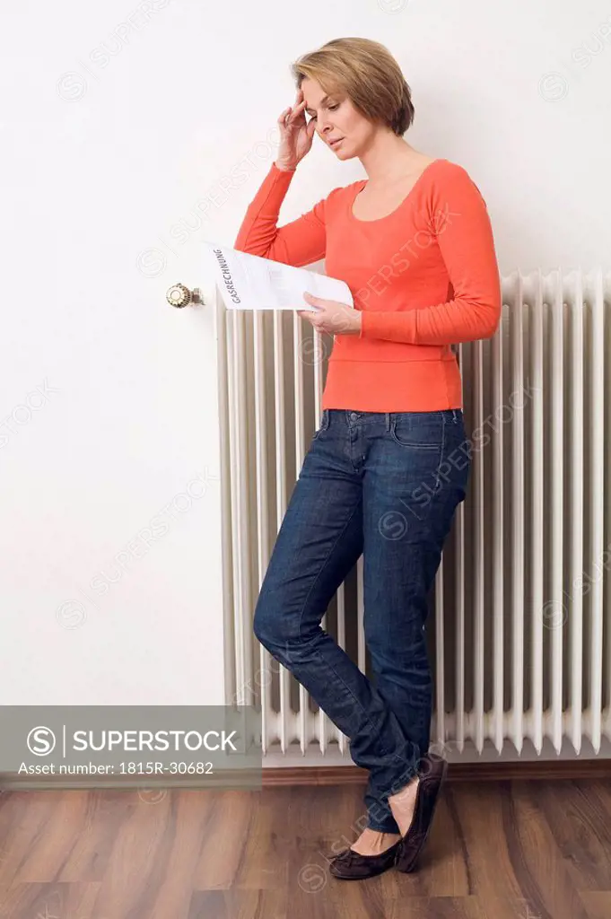 Woman holding utility bill