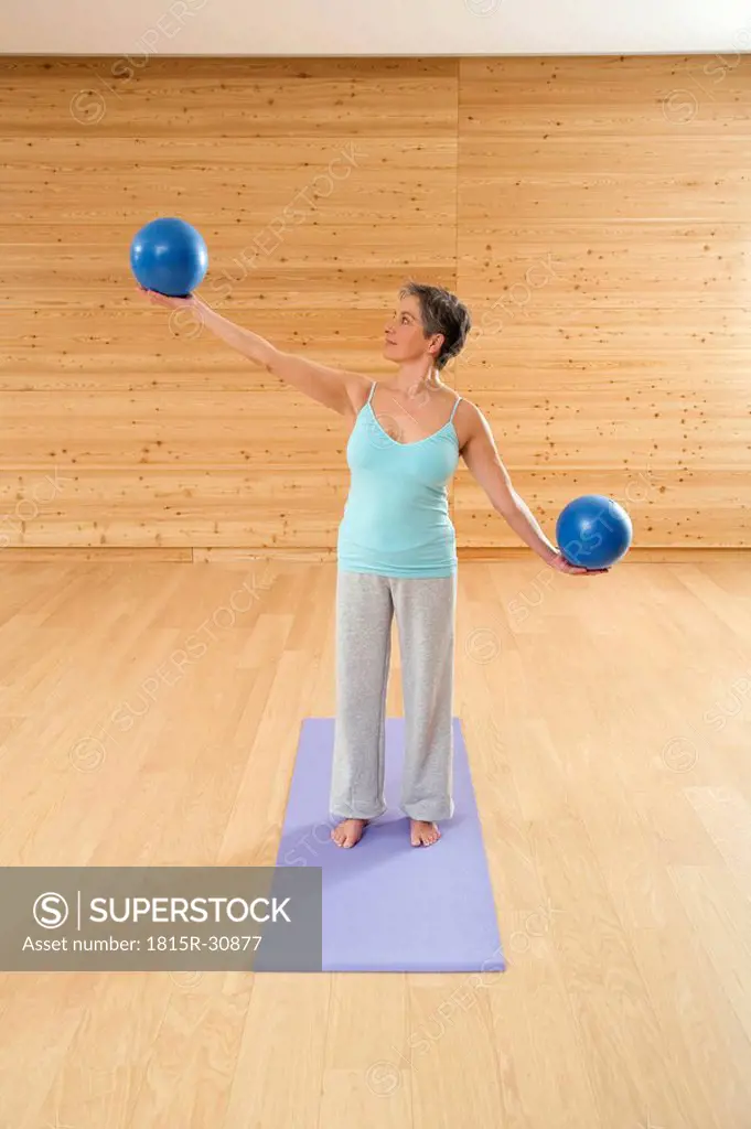 Mature woman with gymnastic ball, portrait