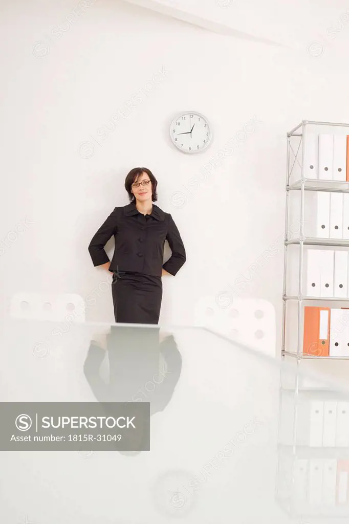 Businesswoman leaning against wall