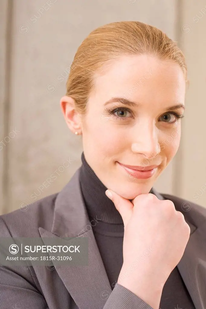 Businesswoman with hand to chin, portrait