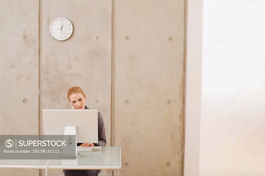 Businesswoman using a laptop, portrait