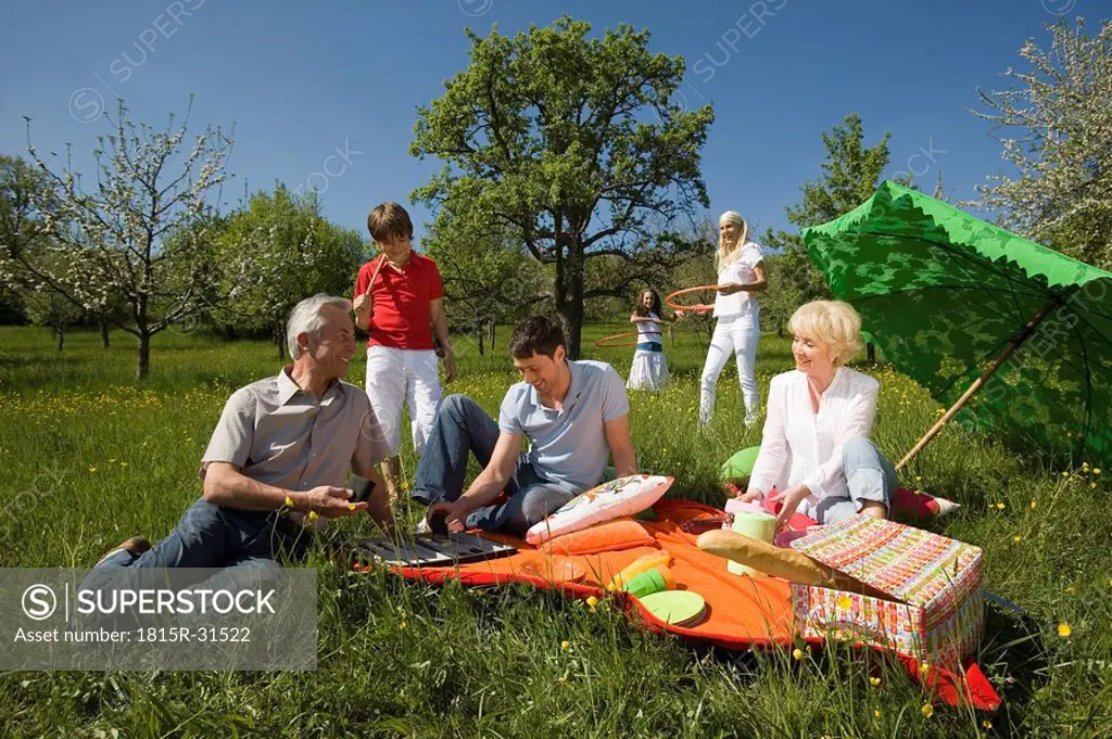 Germany, Baden Württemberg, Tübingen, Three generation family having picnic in meadow