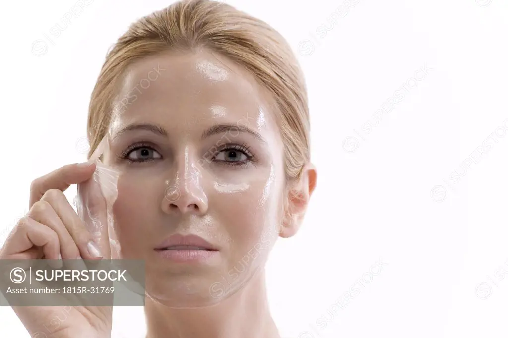 Woman removing face mask