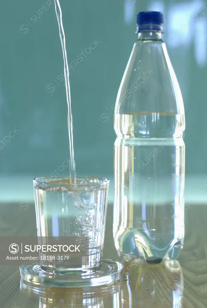 Pouring water into glass, close-up
