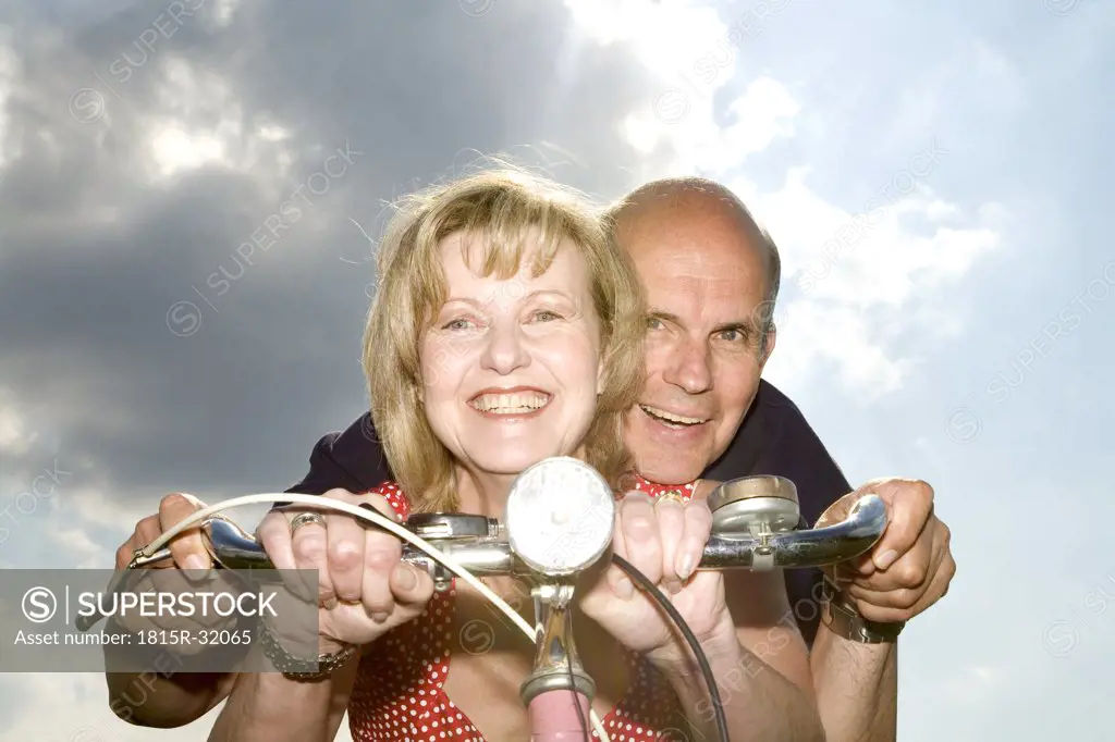 Mature couple riding bike