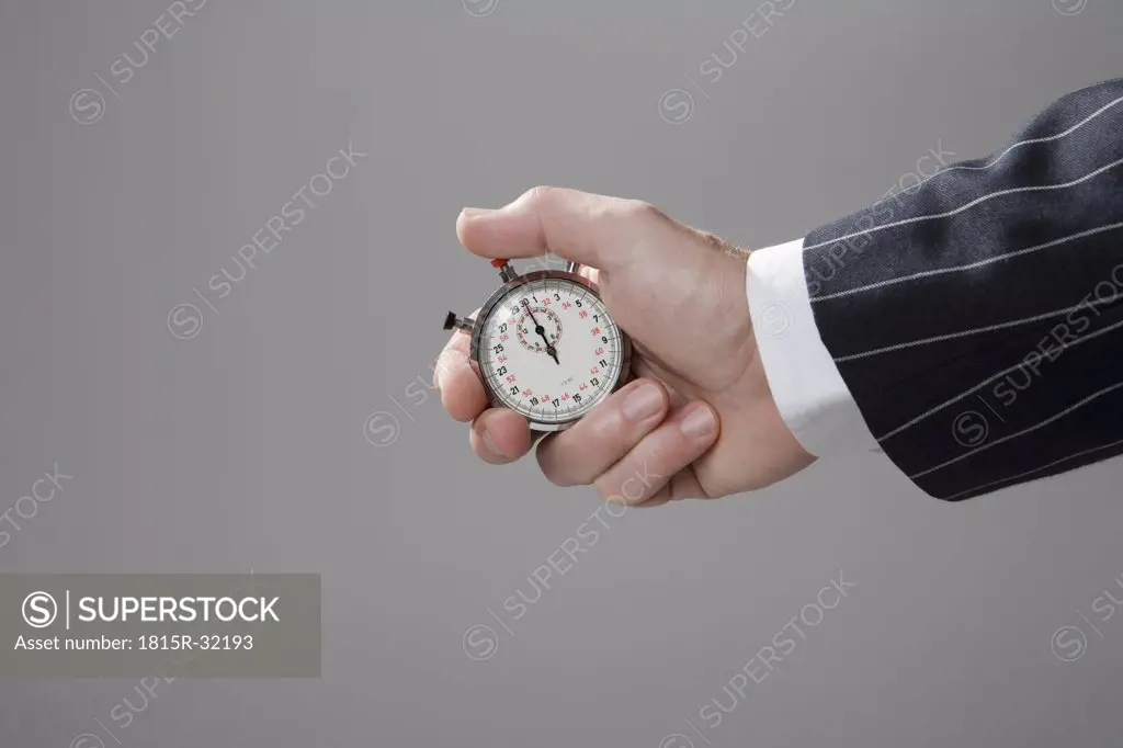 Man holding stop watch, close-up