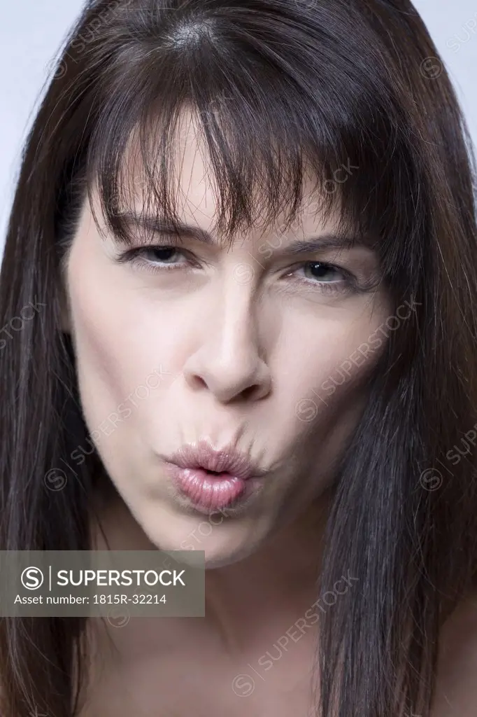 Brunette woman pulling faces, portrait