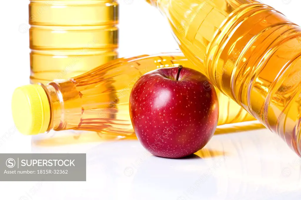 Apple by bottles of apple juice