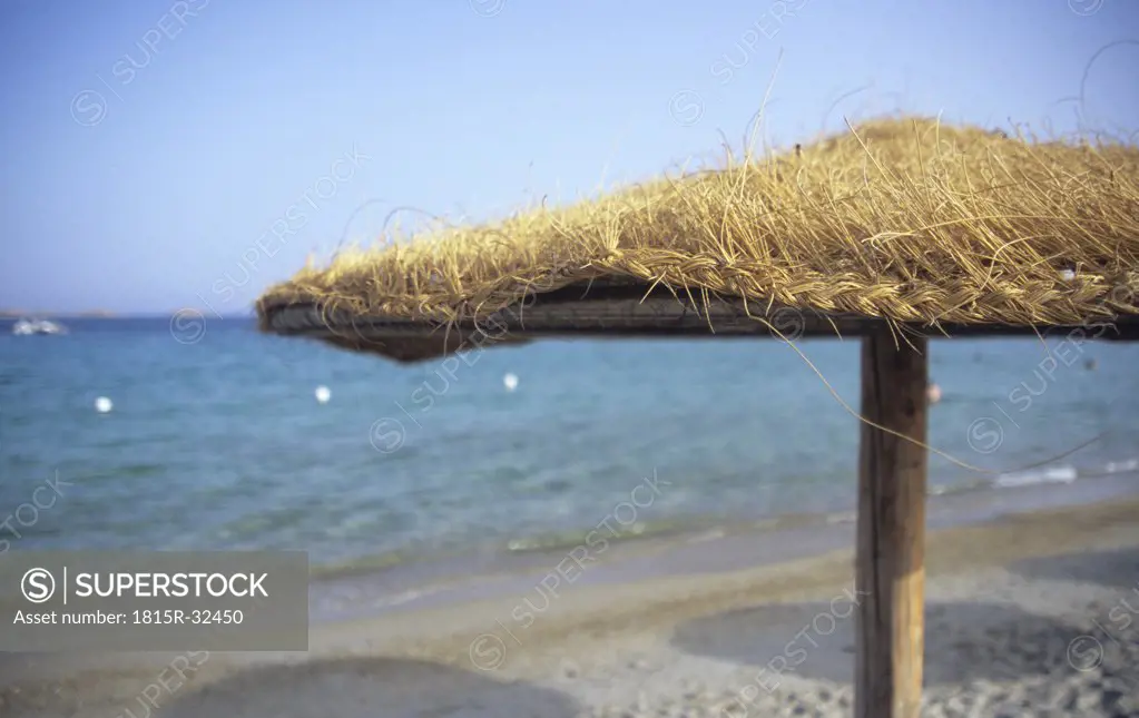 Italy, Sardinia, Beach umbrella on beach