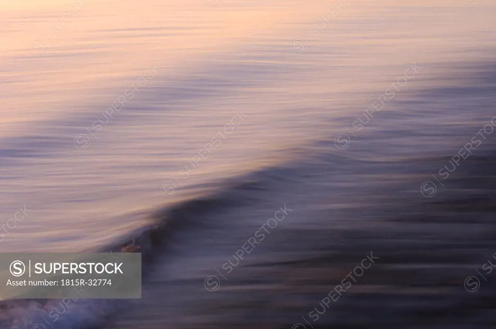 Germany, Lake Constance, Waves in the sunset, blurred view