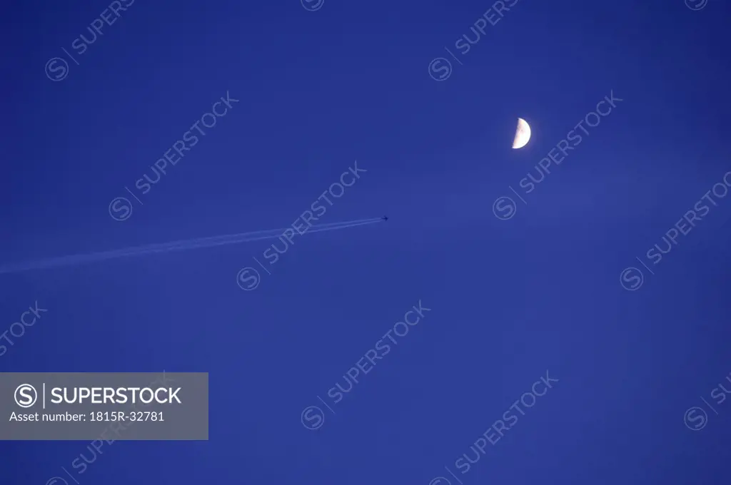 Germany, Markdorf, Airplane in the sky with half moon