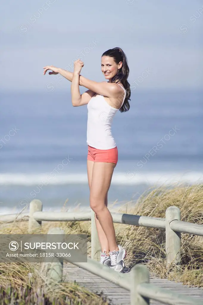 Young woman stretching arms