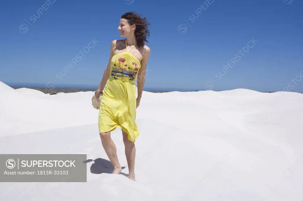 South Africa, Cape Town, Young woman in sand dunes