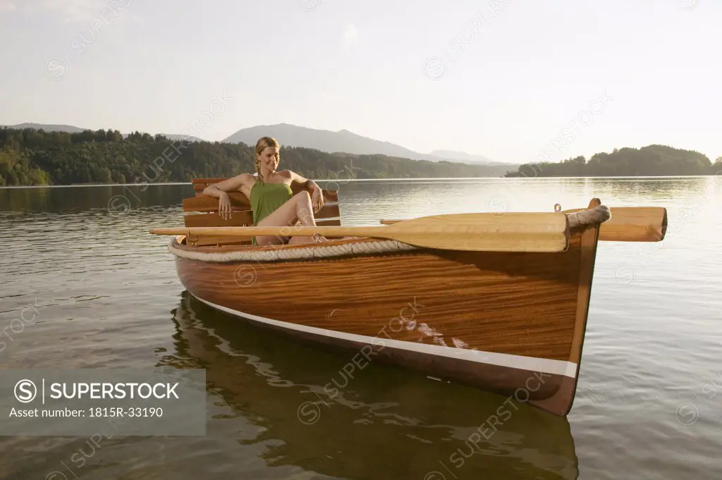 Woman at lake, sitting in rowing boat
