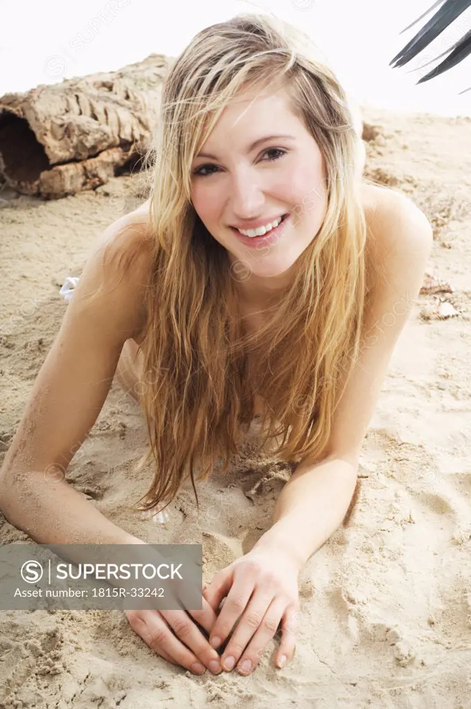Young woman lying on beach