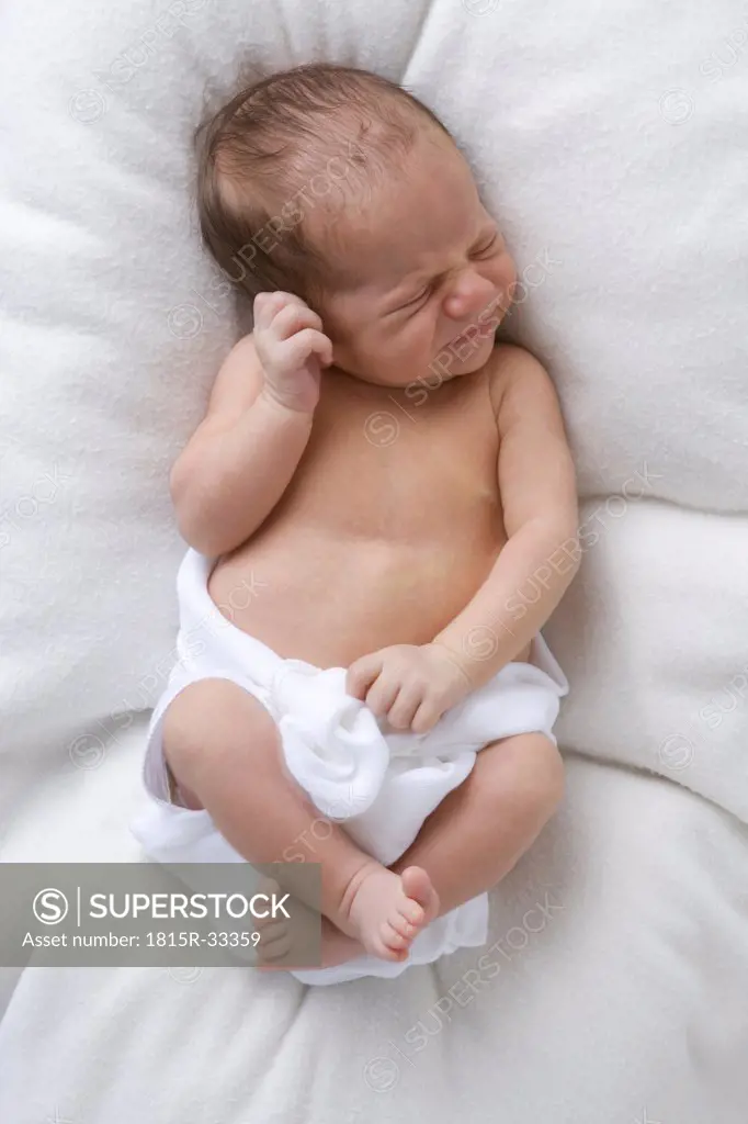Baby in diaper sleeping, elevated view