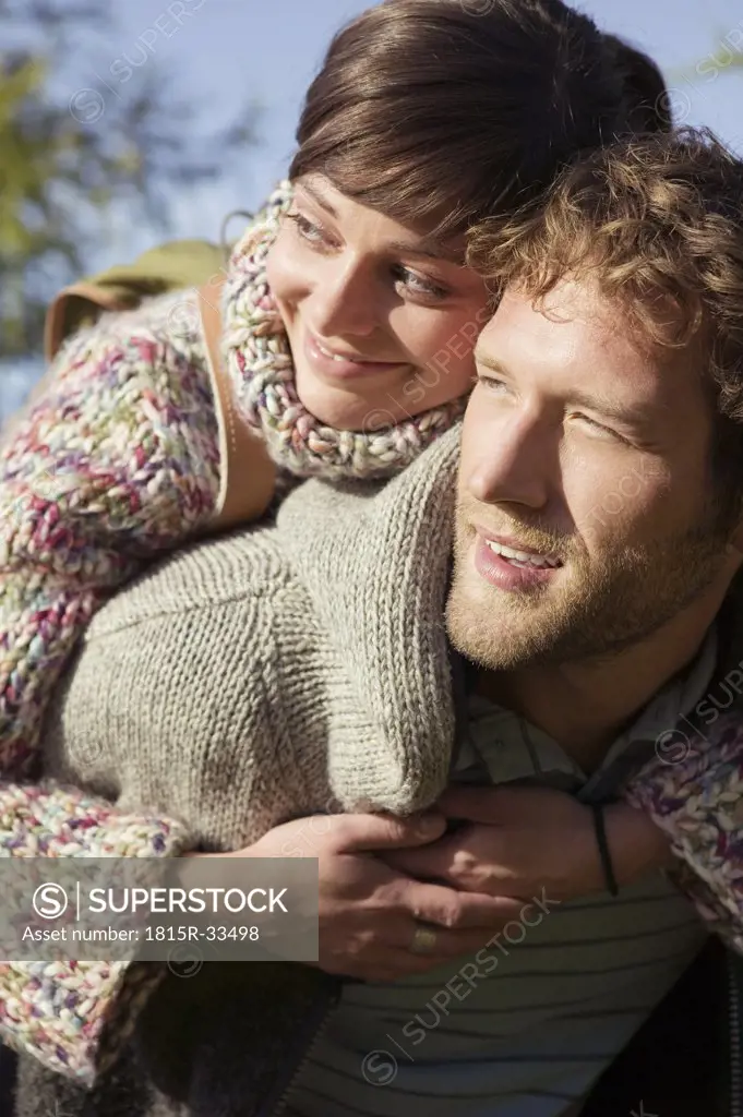 Young couple, woman embracing man, close-up