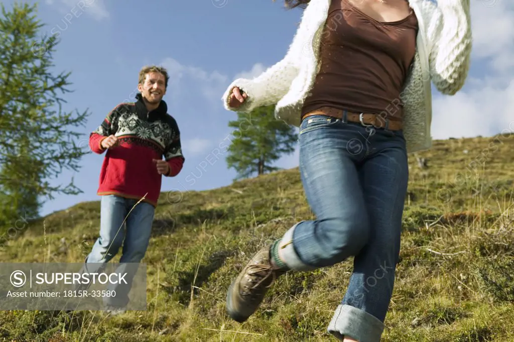Young couple running in mountains